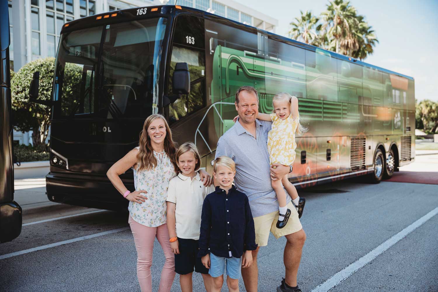 family-posing-in-front-of-bus
